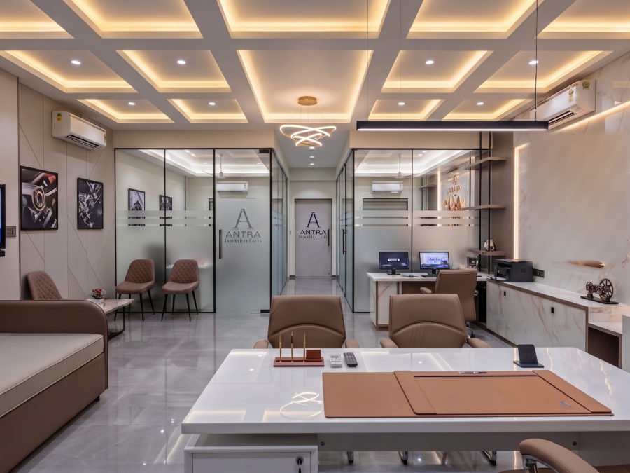 The main Antra office floor with glass-partitioned cabins, a central desk and workstations